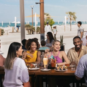 Friends eating at the beach Abu Dhabi